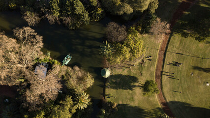 Aerial top-down view on the lake inside the public park with trees and green grass around it, Palermo, Buenos Aires, Argentina 