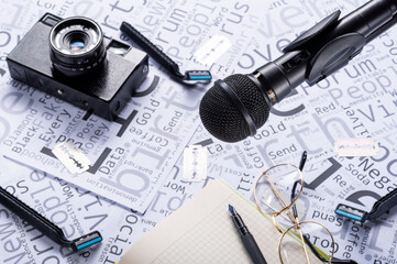 Writer's desk. The desk of a journalist. Microphone, notebook and glasses.