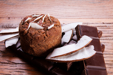 Nutrition concept -Healthy small sweet quiche pie over wooden background. Healthy food, Diet, Detox, Clean Eating or Vegetarian concept. Homemade delicious baked muffin with chocolate and coconut.