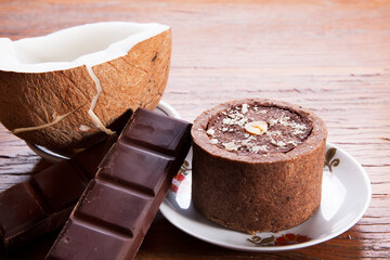 Nutrition concept -Healthy small sweet quiche pie over wooden background. Healthy food, Diet, Detox, Clean Eating or Vegetarian concept. Homemade delicious baked muffin with chocolate and coconut.