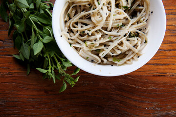 Nutrition concept - Healthy food, Diet, Detox, Clean Eating or Vegetarian concept. Healthy meal made of palm tree pasta in white bowl over wooden background. Top view