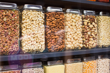 Different types of nuts are packaged in jars for sale