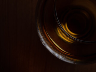 Cognac glass. Part of a cognac glass with brandy and amber flare.