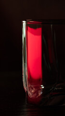 A glass of cognac. A glass of cognac in ruby light.