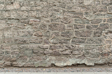 abstract background of stone lined wall and tiled pavment close up