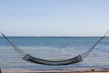 Hammock hanging in front of the calm sea