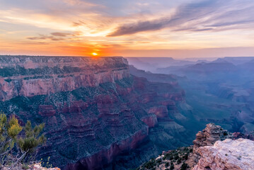 The sunset highlights multi-colored rock strata viewed from Yaki Point on the South Rim of the...