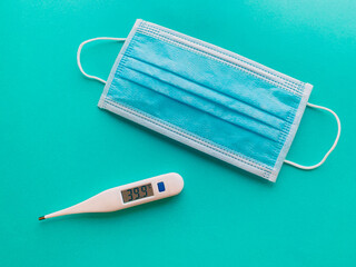 Mask and thermometer in blue background