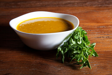 Nutrition concept - Healthy food, Diet, Detox, Clean Eating or Vegetarian concept. Healthy Pumpkin soup puree with fresh pumpkins pieces on an old wooden table.