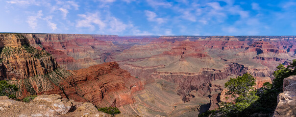 A panorama showing a glimpse of the Colorado River between the colored strata of the Grand Canyon...