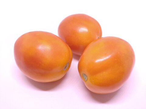 Three fresh tomatos isolated on white