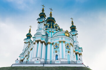 Fototapeta na wymiar Beautiful St Andrew's Church in Kiev with cloudy sky in background