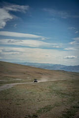Fototapeta na wymiar Car on road in the desert mountain of the Mongolia
