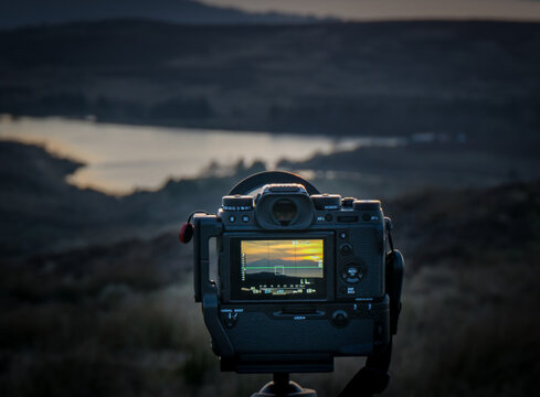 Fairlie, Scotland, UK - February 24, 2018: Rear view of Fujifilm brand XT-2 and attached Fuji Battery grip secured on unseen tripod mount.  Mirrorless cameras like these are increasing in popularity.