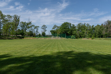 The gate to the distance of the football field. Soccer field and goal. Soccer field in the park.