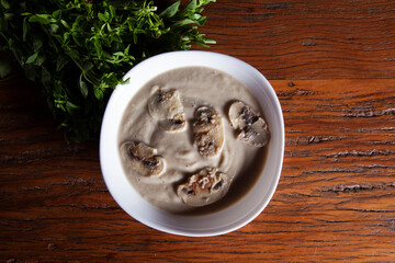 Nutrition concept - Healthy meals in White bowls over wooden background. Healthy food, Diet, Detox, Clean Eating or Vegetarian concept. Delicious soup made of mushrooms.