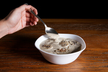 Nutrition concept - Healthy meals in White bowls over wooden background. Healthy food, Diet, Detox, Clean Eating or Vegetarian concept. Delicious soup made of mushrooms.