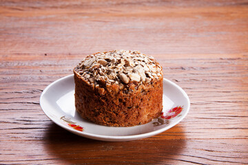 Traditional mini homemade Christmas cake. Holiday dessert with Damascus and dry goji berry on...