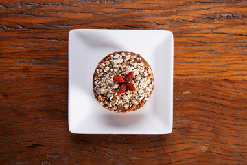 Traditional mini homemade Christmas cake. Holiday dessert with Damascus and dry goji berry on...