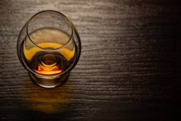 Cognac glass with brandy poured from a top angle.
