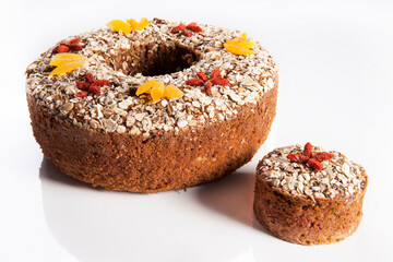 Fruit cake over white background. Traditional homemade Christmas cake with goji berries and...