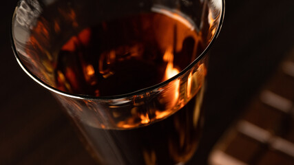 A part of cognac glass with amber-colored cognac.