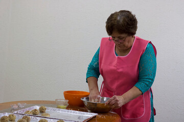 old woman making cookies