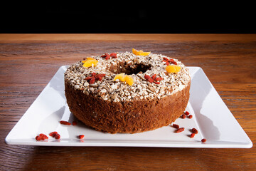 Traditional homemade Christmas cake. Holiday dessert with Damascus and dry goji berry on vintage...