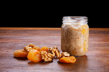 Nutrition concept - Healthy meals made of chicken, nuts and Damascus in bowls over wooden...