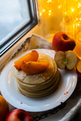 pancakes with fruit on a windowsill in winter