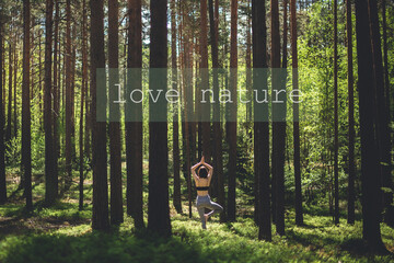 Woman practicing yoga in forest standing on log in yoga tree pose. fitness lifestyle at the outdoors nature background. Sunny day in pine forest. copy space. text "love nature"