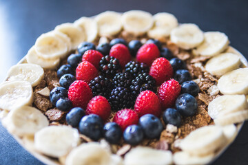 Cereals and fruits superbowl, healthy bowl breakfast with flakes, oat and fruits: raspberries, blueberries, banana, blackberries