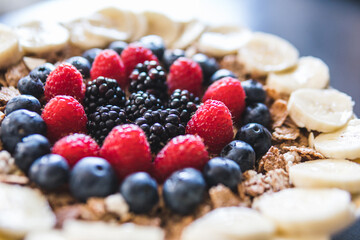 Cereals and fruits superbowl, healthy bowl breakfast with flakes, oat and fruits: raspberries, blueberries, banana, blackberries