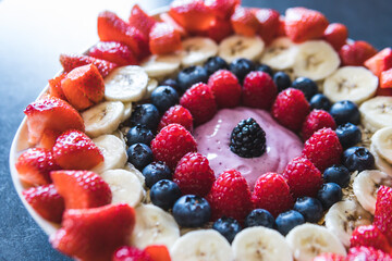 Cereals and fruits superbowl, healthy bowl breakfast with flakes, oat and fruits: strawberries,raspberries, blueberries, banana, blackberries