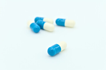 Obraz na płótnie Canvas Blue and white pills on a white background