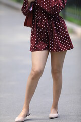 beautiful legs of a girl in burgundy shorts