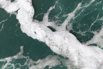 Foam on the turquoise water surface, rapid river flow