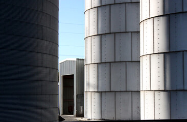 Grain elevators and silos with sky and clouds from different perspectives