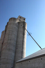 Grain elevators and silos with sky and clouds from different perspectives