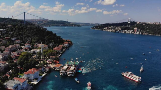 Aerial view of people swimming between Europe and Asia 4K. Bosphorus bridge drone footage 4K
