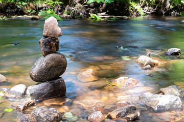 Balanced zen rocks at the river at Rivelin Valley near Sheffield in South Yorkshire. Select focus, long exposure.
