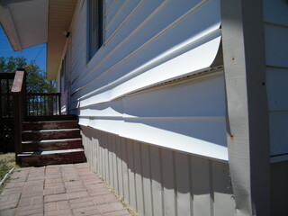 Damaged Vinyl Siding on a House