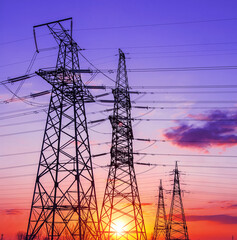  high-voltage  power lines at sunset.
