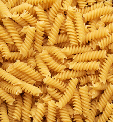 a bunch of raw fusilli pasta, top view, full frame