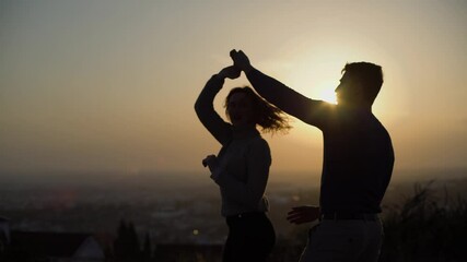 Couple dancing with man turning woman leading her into dip