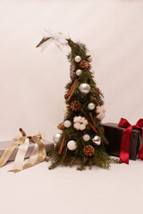 miniature christmas tree with decorations  gold and silver and gifts