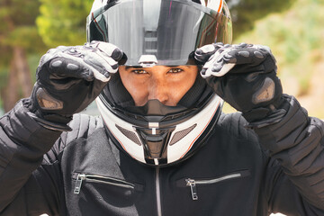 close-up portrait of a biker holding his helmet