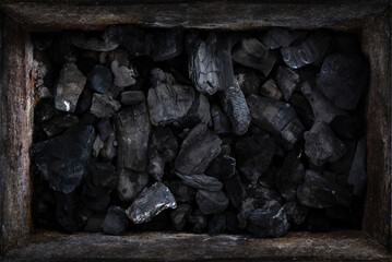 black burnt charcoal  in the rusted metal box texture background
