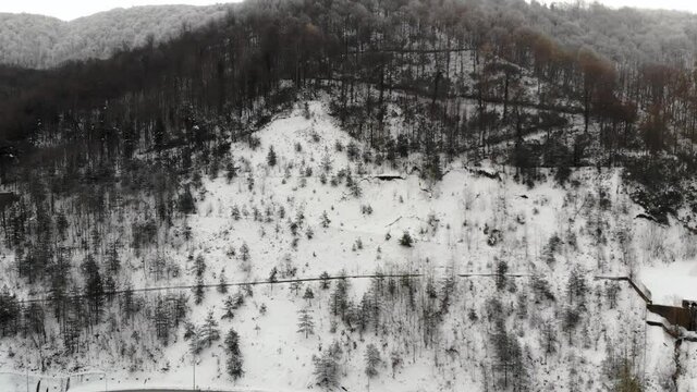Flying over snowy mountains in Abant National Park, Turkey. Drone footage 4K