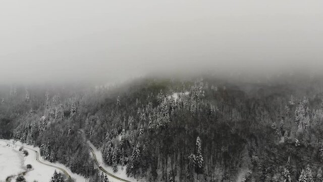 Drone footage of Abant in winter time. Snowy weather, beautiful mountains with dense forest. Aerial view 4K 